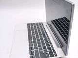 a white laptop with a black keyboard on a white surface