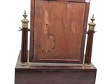 a wooden frame with a mirror on top of it