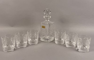 six glasses and a decanter sitting on a table