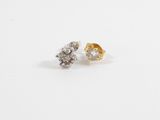 a pair of diamond stud earrings on a white background