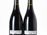 two bottles of wine sitting next to each other on a table