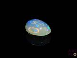 an image of a white fire opal in the dark