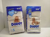 two packs of baby diapers sitting on top of a white counter