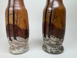 two vases that have been painted with trees on them