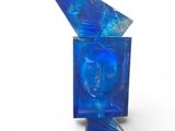 an image of a blue glass sculpture with a face on it