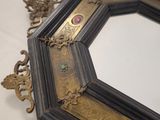 a mirror that is sitting on a table with a white table cloth