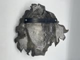 a metal object on the wall with a ruler in it
