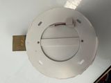 a close up of a white toilet with a metal lid