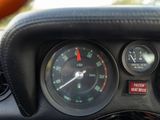 a close up of a car dashboard with a clock and gauges