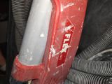 a close up of a red and white vacuum cleaner