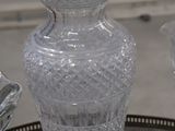 three glass vases sitting on a tray on a table