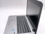 a silver laptop with a blue sticker on the screen