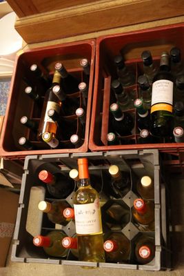 many bottles of wine in a case on the floor
