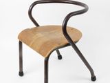 an image of a wooden chair with black legs and a bent back