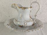 a white pitcher and saucer sitting on a white table