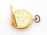 an image of a gold pocket watch on a white surface