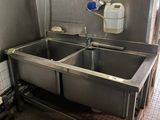 two sinks in a public bathroom with a faucet