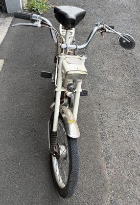 motorcycle parked on the side of the road in front of a building