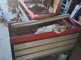 a bench that is sitting in a garage with a lot of tools