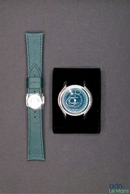 a watch that is sitting next to a watch case