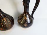 two vases sitting next to each other on a table