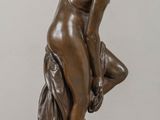 statue of a woman bending over with her hands on her knees