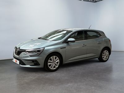 a grey car is parked in a large room with a white wall