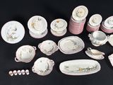 many different types of porcelain dishes and bowls on the table