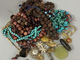 a pile of assorted beads and jewelry on a table