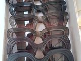 many pairs of sunglasses in a box on the table