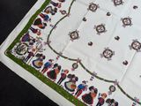 a white table cloth with a picture of a group of people on it