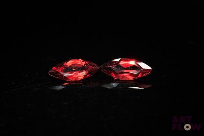a pair of red diamonds on a black surface