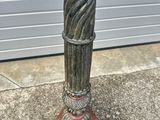a statue of a cat sitting on top of a pedestal