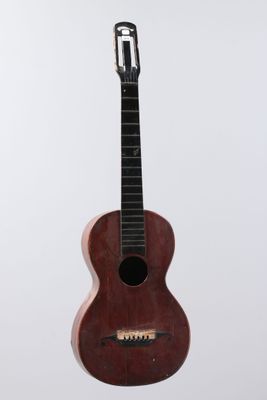 a close up of a small wooden guitar on a white background