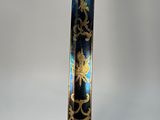 a close up of a blue and gold decorated sword on a stand