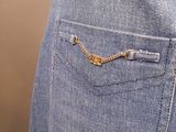 the back pocket of a pair of jeans with a chain on it