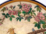 a plate with a bird and flowers on it