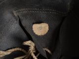 a close up of a black leather jacket with a tag on it