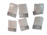 six sacs de riz blanc posés sur une surface blanche