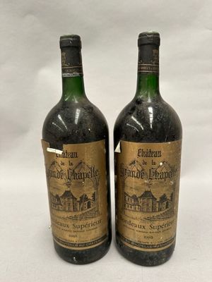 two bottles of wine sitting next to each other on a white surface