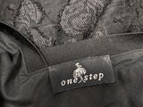 a close up of a black jacket with a one step label on it