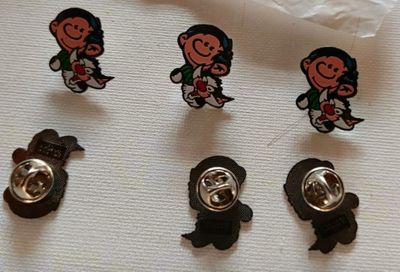 five pins that are sitting on top of a piece of paper