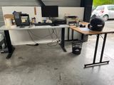a computer desk with a helmet on it in a garage