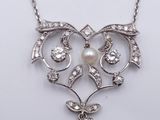 a close up of a necklace on a white surface