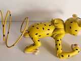a yellow toy dog with a hula hoop on a table