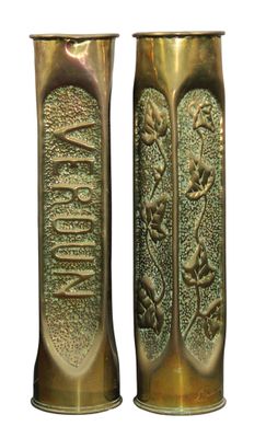 pair of antique brass vases with a design of flowers and leaves