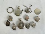 many different types of pocket watches on the table