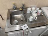 a sink that has a lot of cups in it