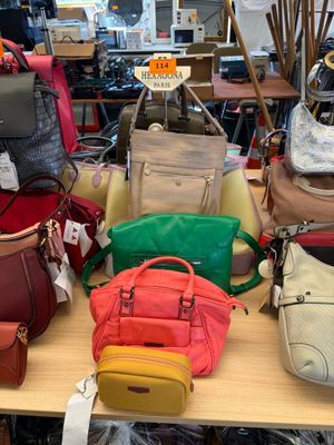 a lot of purses on a table in a store