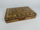 a small wooden box with a decorative design on the inside